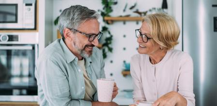 Shot of a mature smiling couple drinking coffee together in the kitchen at home.