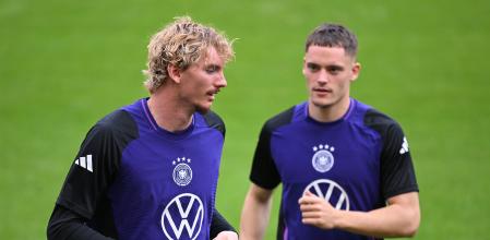 COLOGNE, GERMANY - SEPTEMBER 06: Nick Woltemade and Florian Wirtz of Germany warm up during the training session of the German national football team at RheinEnergieStadion on September 06, 2025 in Cologne, Germany. (Photo by Stuart Franklin/Getty Images)