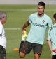 Portugal's Cristiano Ronaldo looks at coach Fernando Santos while stretching during a training session in Oeiras, outside Lisbon, Monday, Aug. 30, 2021. Portugal will play Ireland on Wednesday in a Qatar 2022 World Cup qualifying match. (AP Photo/Armando Franca)