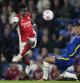 Arsenal's Eddie Nketiah, left vies for the ball with Chelsea's Thiago Silva during the English Premier League soccer match between Chelsea and Arsenal at Stamford Bridge in London, Wednesday, April 20, 2022. (AP Photo/Frank Augstein)
