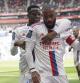 Lyon's Alexandre Lacazette, front, celebrates scoring his side's 2nd goal during the French League One soccer match between Lyon and Rennes at the Groupama stadium, in Decines, near Lyon, France, Sunday, April 9, 2023. (AP Photo/Laurent Cipriani)