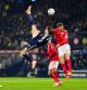 Scotland's Scott McTominay scores the opening goal with an overhead kick during the 2026 World Cup European Qualifying soccer match between Scotland and Denmark at Hampden Park, Glasgow, Scotland, Tuesday, Nov. 18, 2025. (Andrew Milligan/PA via AP)