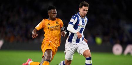 Vinicius Junior of Real Madrid duels for the ball with Martin Zubimendi of Real Sociedad